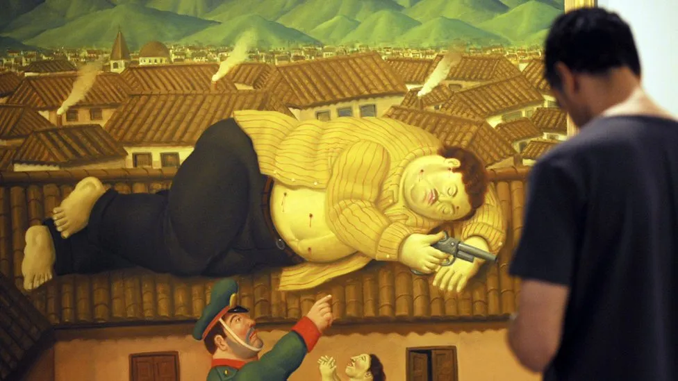 Visitor viewing Fernando Botero's dramatic large-scale painting of a fallen figure at a Colombian museum